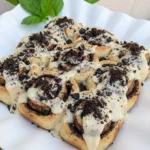 Cookies and Cream Cinnamon Rolls baked until lightly golden with cream cheese frosting and cookie crumbs.