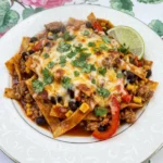 Healthy Enchilada Skillet served with melted cheese cilantro and lime.