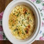 Crockpot Mac and Cheese with melted cheddar and browned edges