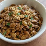 Roasted Pumpkin Seeds with Parmesan in a white bowl with golden toasted seeds and Parmesan crumbs Recipe focus: how to make roasted pumpkin seeds with parmesan.