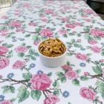 Roasted Pumpkin Seeds with Salt and Pepper piled in a white ceramic ramekin with golden edges and black pepper flecks