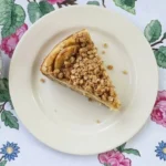 Apple Crisp Cheesecake with golden crumble topping and apple layers Recipe focus: apple crisp cheesecake recipe.