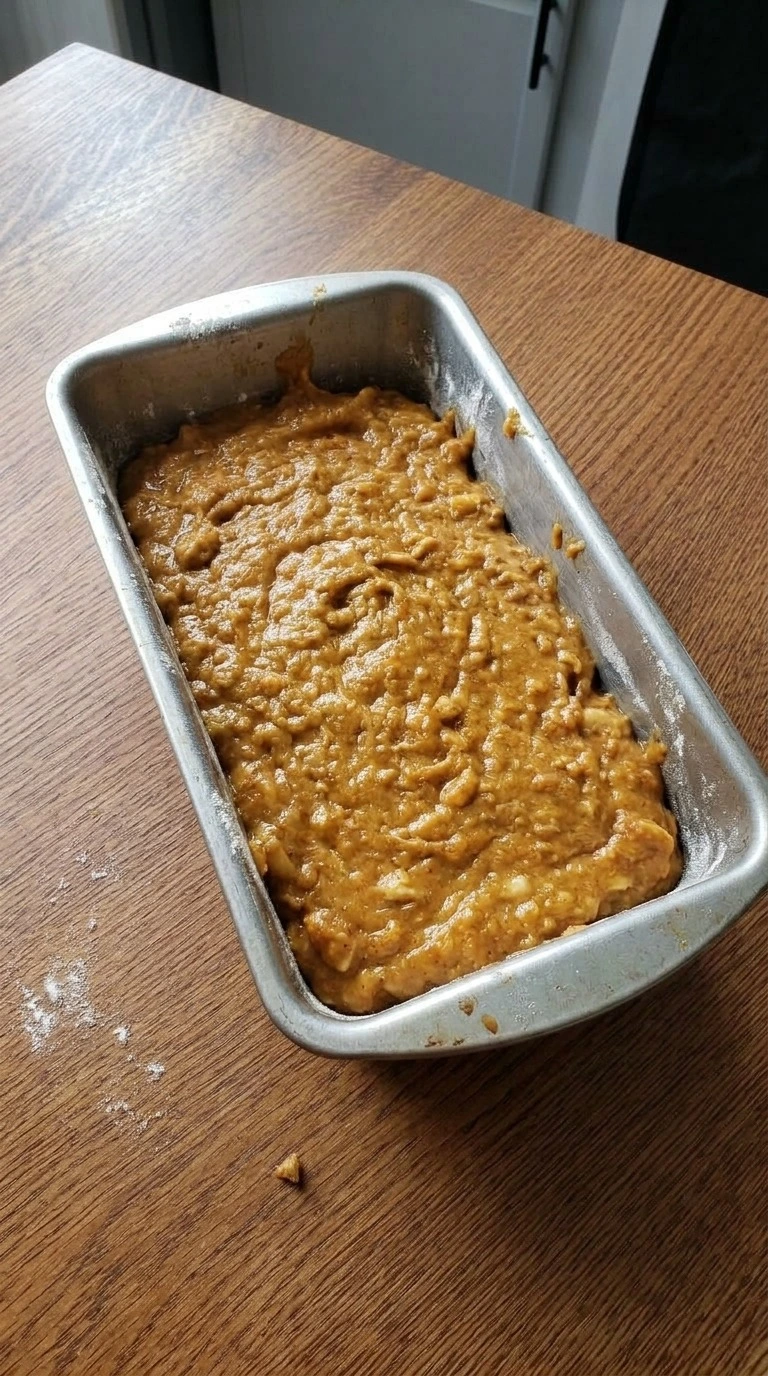 Banana Pumpkin Bread batter in loaf pan before baking with pumpkin color Recipe focus: sugar free pumpkin bread.