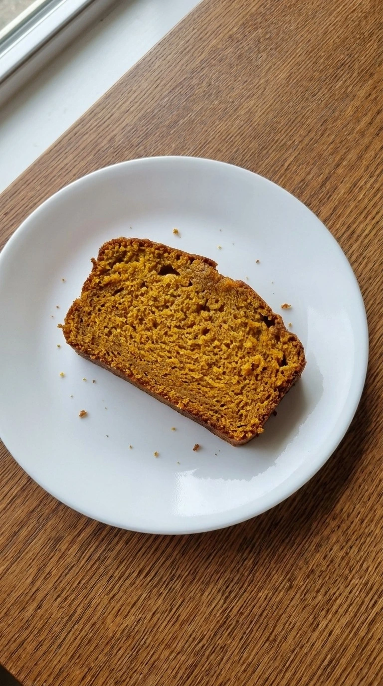 Brown Butter Pumpkin Bread slice showing moist pumpkin crumb on plate Recipe focus: pumpkin bread with icing.