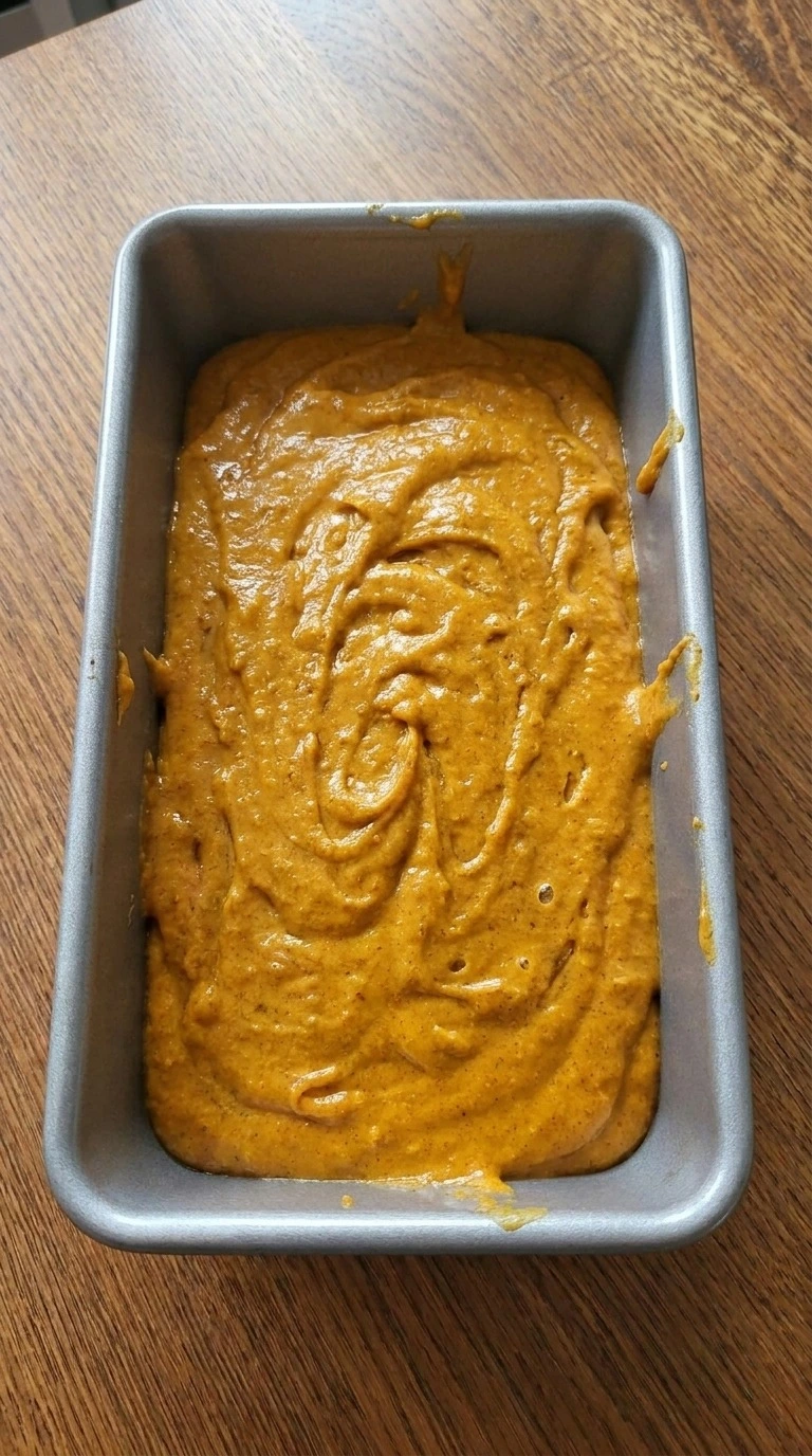 Cake Mix Pumpkin Bread batter filling loaf pan before baking Recipe focus: pumpkin bundt cake with box cake.
