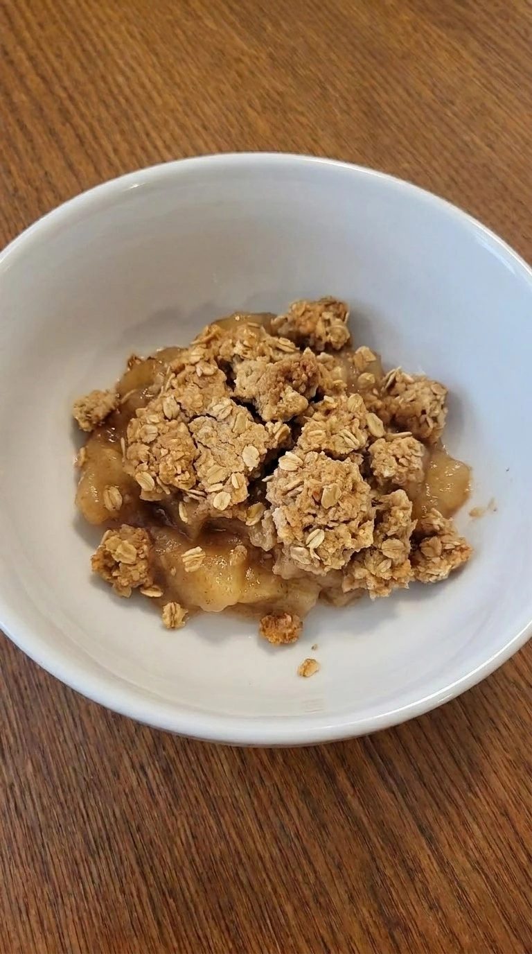 Crockpot Apple Crisp with Pie Filling single serving with golden crumble topping. Recipe focus: crock pot apple crisp with pie filling.