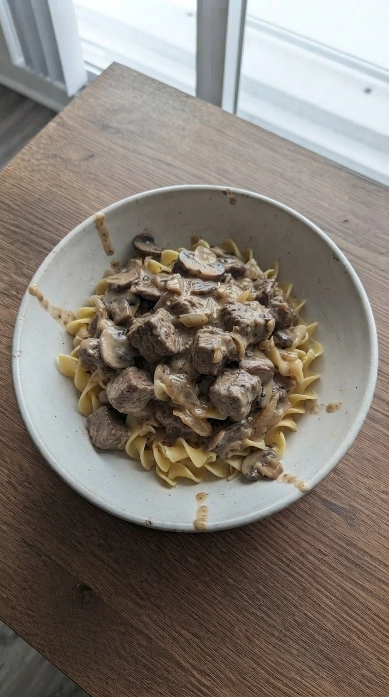 Crockpot Beef Stroganoff plated with creamy beef sauce and egg noodles Recipe focus: slow cooker beef stroganoff.