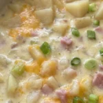 Crockpot Potato Soup with creamy broth, potato chunks and ham in a serving bowl Recipe focus: potato soup crock pot.