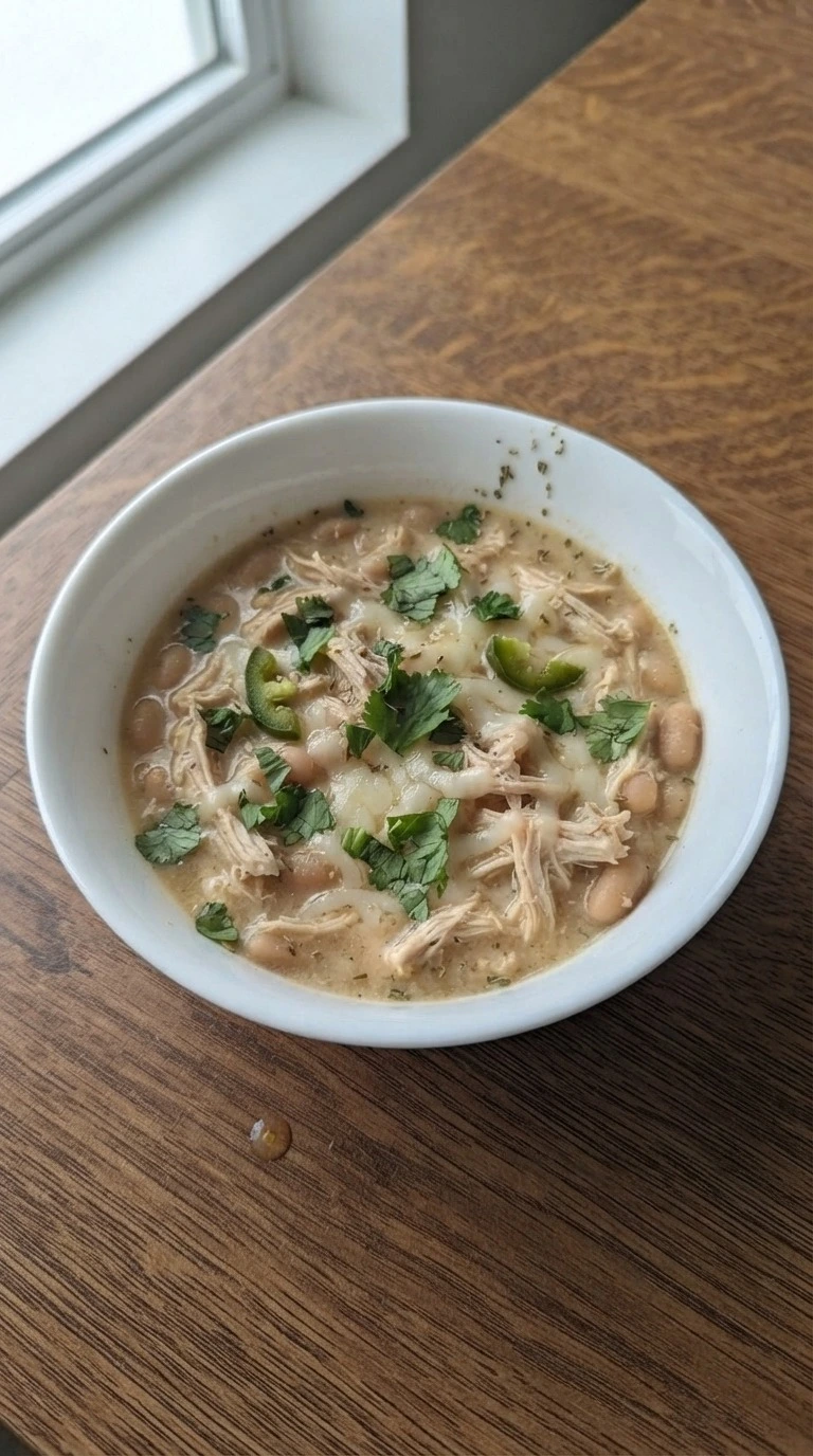 Crockpot White Chicken Chili served bowl with toppings and creamy texture Recipe focus: chicken chili recipe.