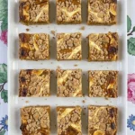 Fall Desserts with Cream Cheese shown as pumpkin crumb bars with golden topping and creamy marbled centers.