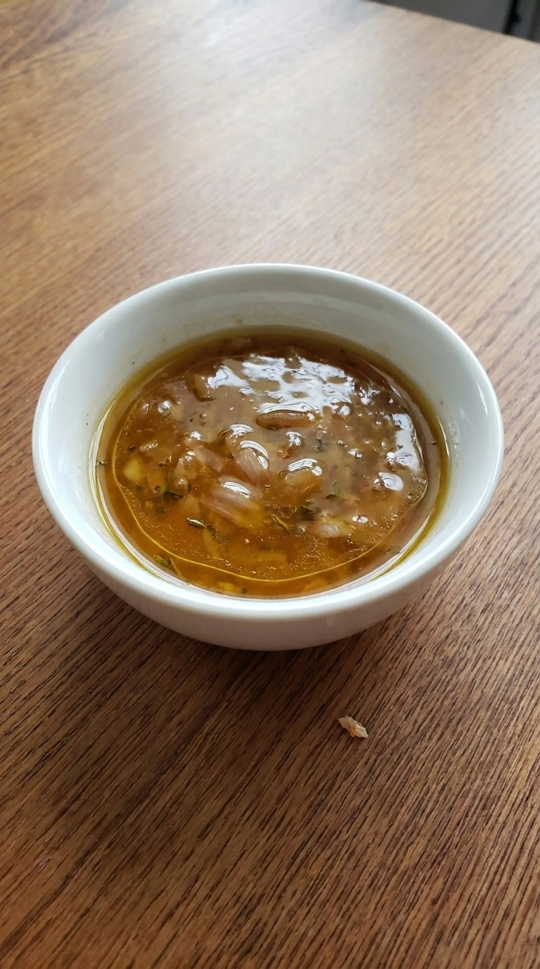 Fall Salad Dressing rested and portioned in a small white bowl with shallot and thyme flecks Recipe focus: best salad dressing.