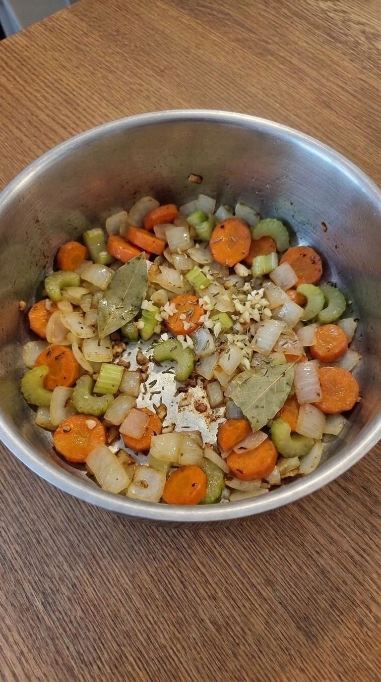 Softened carrots, celery and onion for Gluten Free Chicken Noodle Soup with thyme and garlic