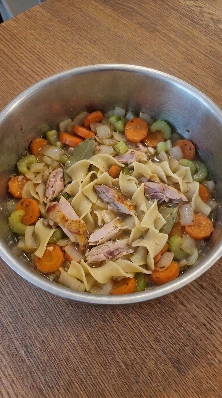 Tender gluten-free noodles and shredded chicken in Gluten Free Chicken Noodle Soup broth