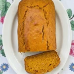 Gluten Free Pumpkin Bread Almond Flour loaf with a golden crust and moist orange sliced crumb.