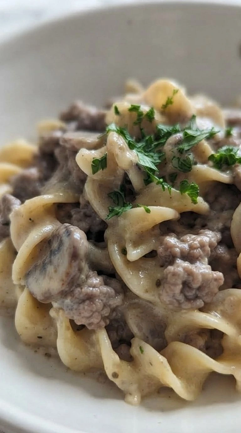 Ground Beef Stroganoff with creamy mushroom sauce and browned beef in a serving bowl Recipe focus: beef stroganoff recipe.