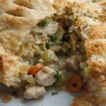 Homemade Chicken Pot Pie with golden crust and creamy filling on a plate Recipe focus: easy chicken pot pie.