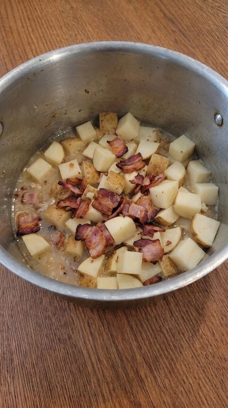 Loaded Baked Potato Soup base simmering with softened russet potatoes Recipe focus: potato soup recipe.
