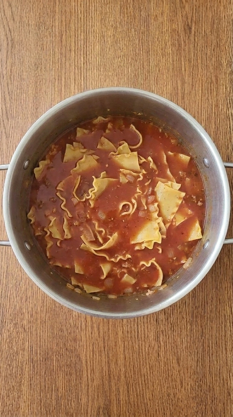 One Pot Lasagna Soup noodles cooking in rich tomato broth Recipe focus: easy lasagna soup.