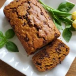 Pumpkin Bread with Chocolate Chips loaf with sliced golden top and chocolate pieces Recipe focus: chocolate chip pumpkin bread recipe.