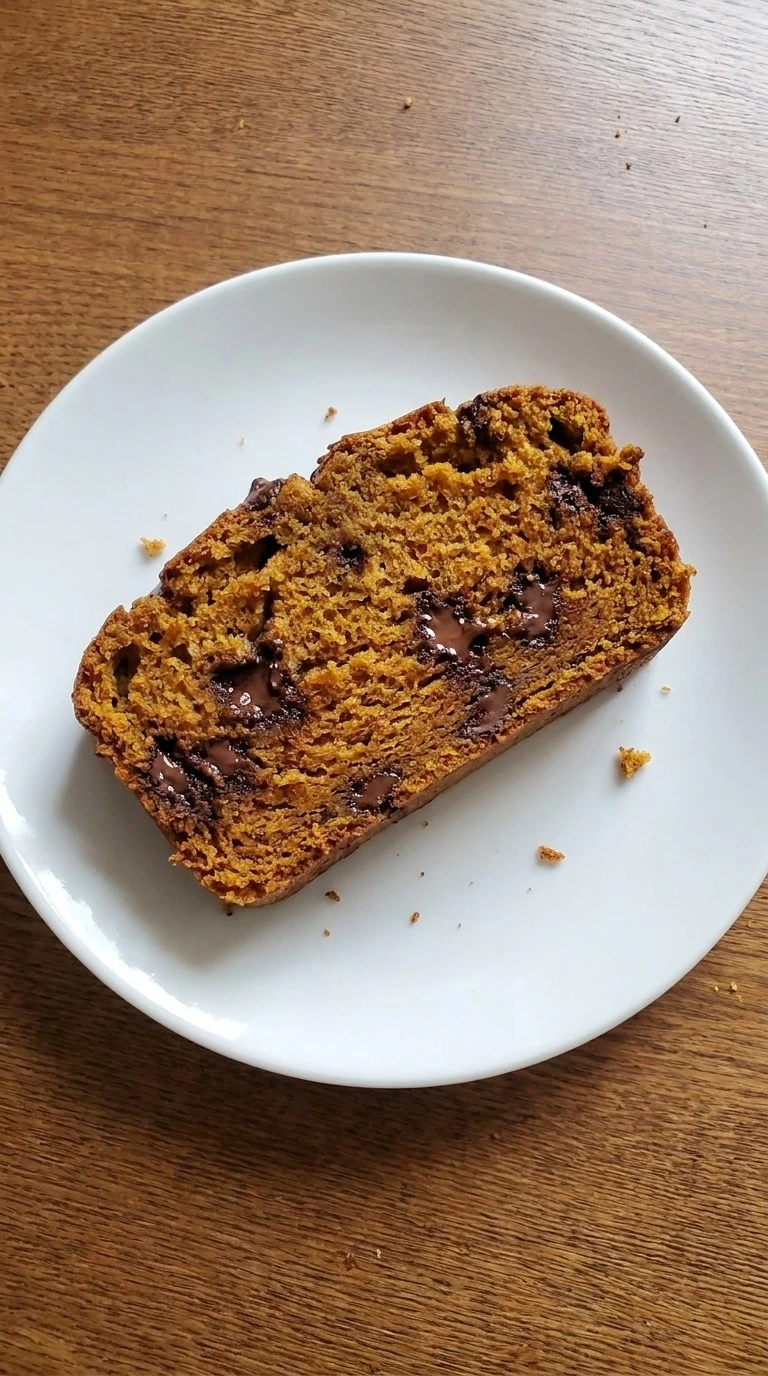 Pumpkin Bread with Chocolate Chips slice showing moist crumb and chocolate pockets Recipe focus: pumpkin chocolate chip cake.
