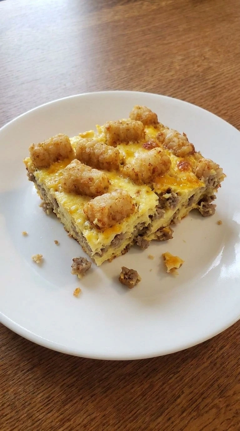 Tater Tot Breakfast Casserole single serving on plate with crispy topping Recipe focus: hashbrown breakfast casserole.