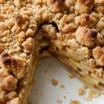 Apple Crumble Pie with golden buttery crumbs, cinnamon apples and a flaky crust in a round pie dish. Recipe focus: easy apple crumble pie.
