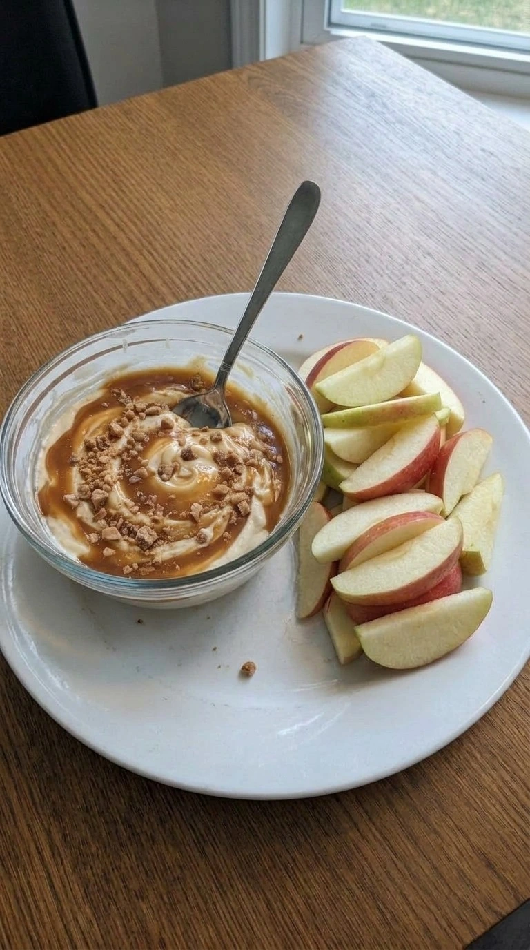 Cream Cheese Caramel Apple Dip final serving with apple wedges and toffee Recipe focus: caramel apple cheesecake dip.