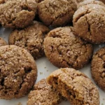 Gluten Free Gingerbread Cookies with crackled brown tops and soft centers on a white plate Recipe focus: gingerbread cookies gluten free.