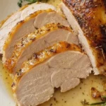 Herb Butter Roasted Turkey Breast with golden skin and thick juicy slices on a serving platter Recipe focus: easy herb butter roasted turkey breast.
