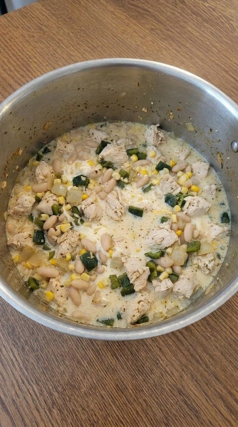 Mexican Street Corn White Chicken Chili turning creamy with melted cheese and chicken Recipe focus: crockpot white chicken chili.