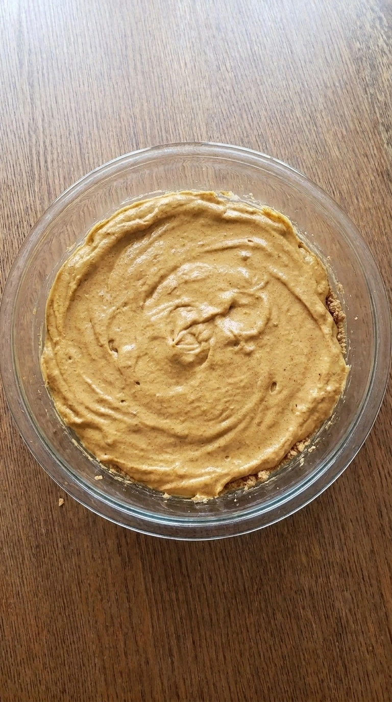 No Bake Pumpkin Cheesecake filling folded with whipped cream in pan Recipe focus: pumpkin cheesecake recipes.