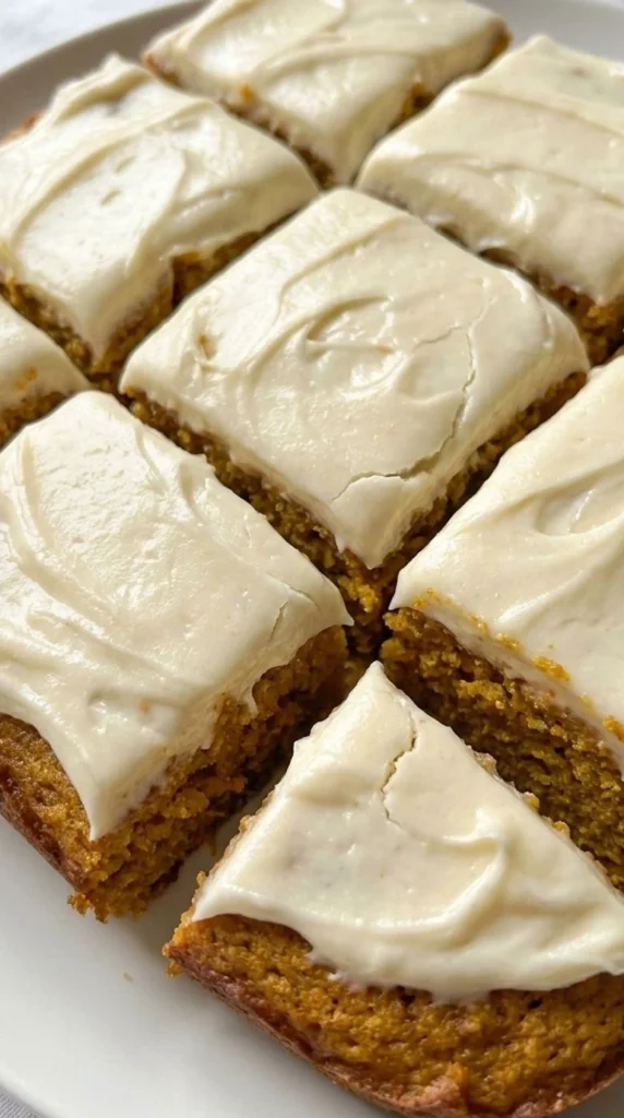 Pumpkin Bars with Cream Cheese Frosting sliced squares with creamy topping Recipe focus: pumpkin bars recipe.