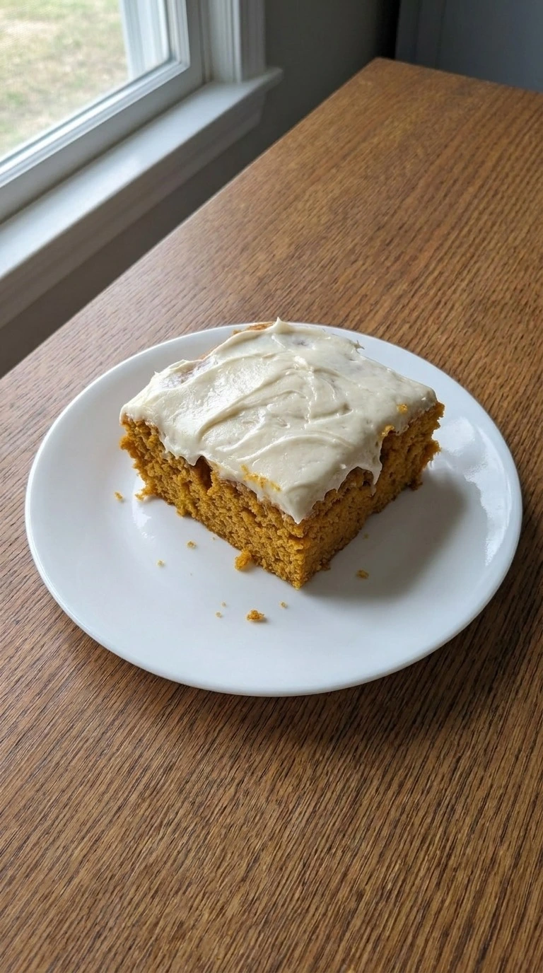 Pumpkin Bars with Cream Cheese Frosting sliced square showing cake layers Recipe focus: pumpkin bars recipe.