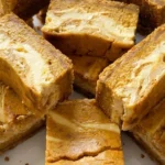 Pumpkin Cheesecake Bars sliced with creamy orange and cheesecake layers Recipe focus: pumpkin bars.