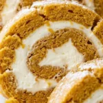 Pumpkin Roll with Cream Cheese Filling sliced dessert showing orange cake and cream cheese swirl layers Recipe focus: pumpkin roll recipe.
