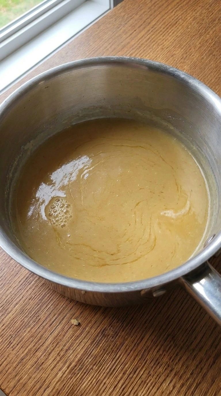 Turkey Gravy Without Drippings step two showing turkey broth blended into a golden roux Recipe focus: turkey gravy without drippings recipe.